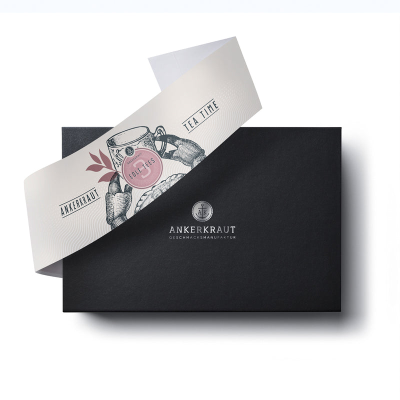 Tea-Time Geschenk Box aus schwarzem Karton mit diagonaler Banderole.