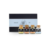 Traveller Plus Geschenk-Box aus schwarzem Karton mit vier Korkengläsern davor.
